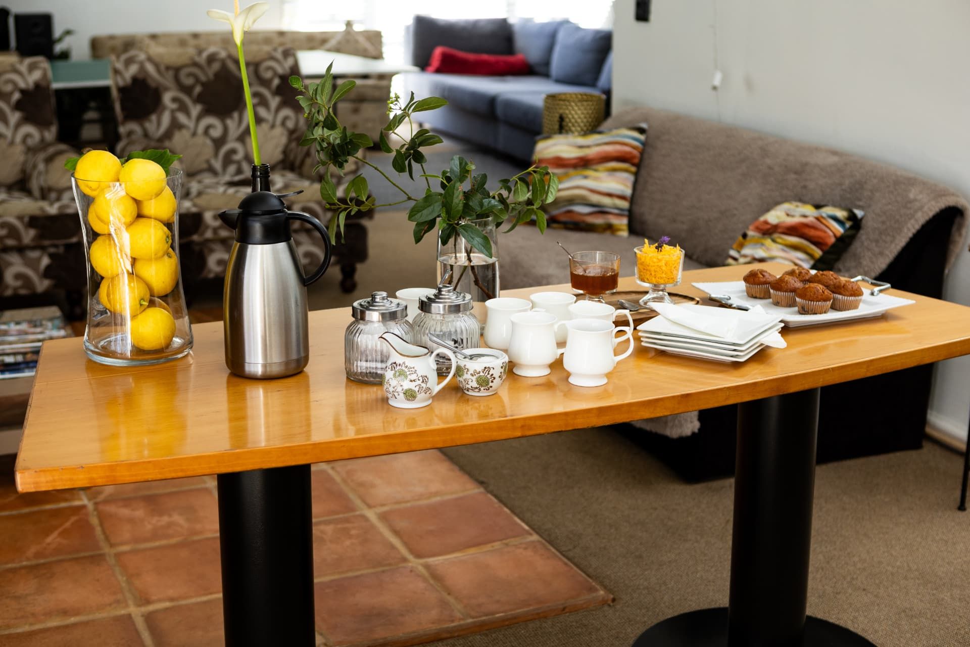 Hospitality table with lemons, coffee and muffins in the guest lounge