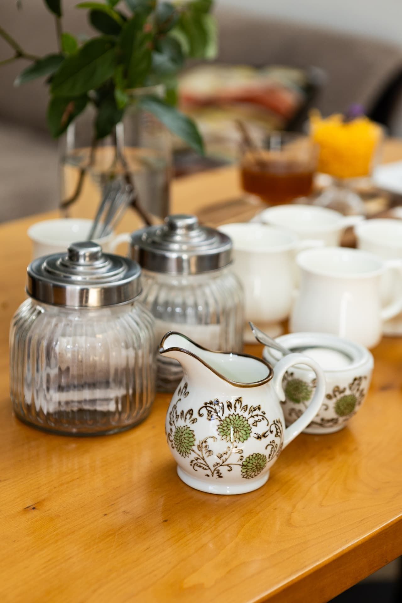 Tea and coffee jars with floral milk jug in the guest lounge