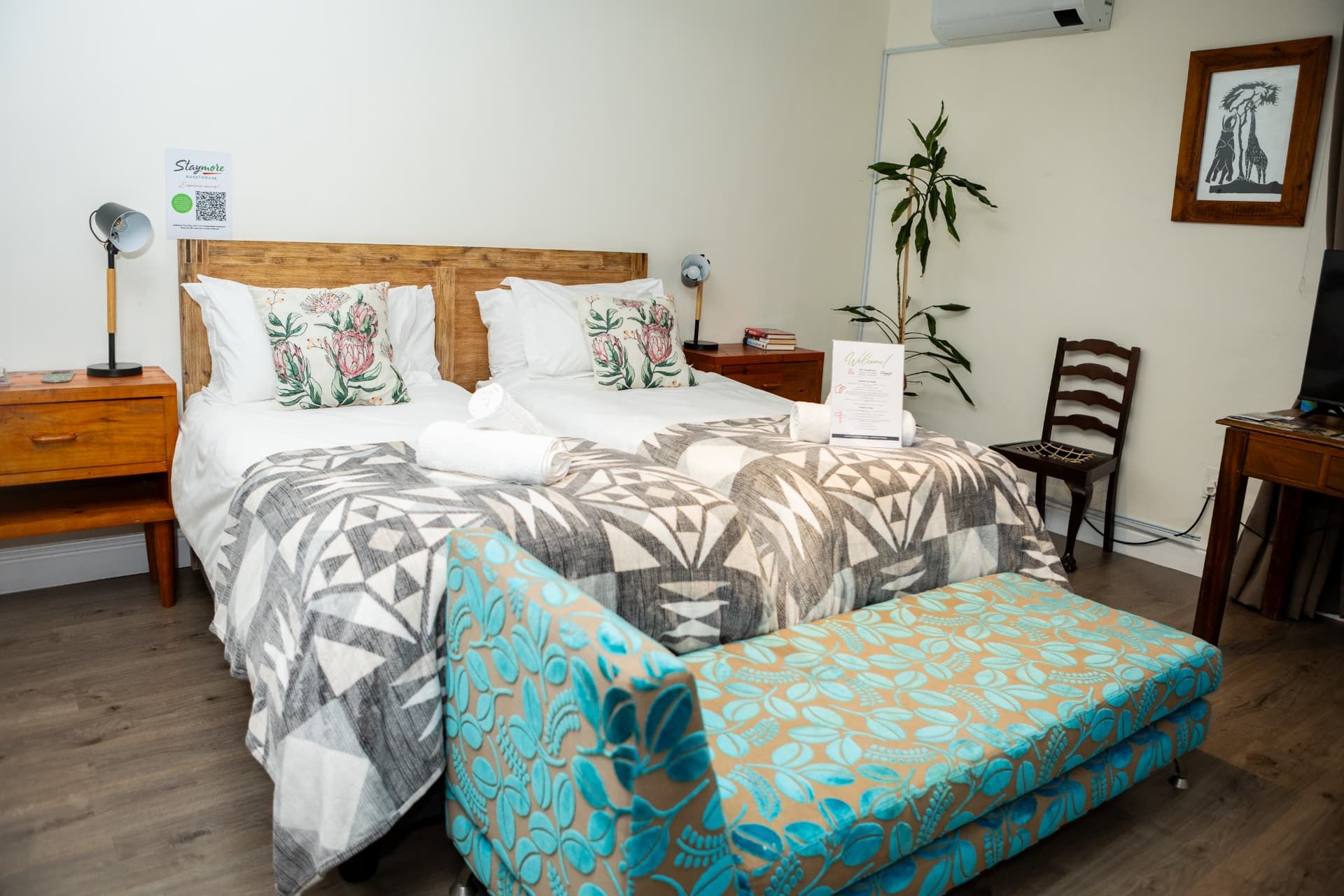 Twin beds with protea cushions in a Staymore room